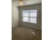 Bright bedroom with a ceiling fan, and a window with blinds that looks out into the neighborhood at 5208 Fernland Way, North Charleston, SC 29420