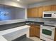 Functional kitchen with natural wood cabinets and modern appliances, open to the adjacent living area at 5208 Fernland Way, North Charleston, SC 29420