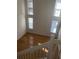 View from stairs of a bright and airy living room with vaulted ceilings and hardwood floors at 5208 Fernland Way, North Charleston, SC 29420