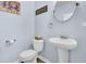 Cozy half bathroom featuring a pedestal sink, toilet, and decorative elements at 543 Wayton Cir, Moncks Corner, SC 29461