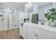 Bright bathroom featuring a double sink vanity, framed mirrors, decor, and a glass enclosed shower at 543 Wayton Cir, Moncks Corner, SC 29461