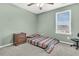 Bedroom features a ceiling fan, a bed with striped blanket, a window, and wood nightstand at 543 Wayton Cir, Moncks Corner, SC 29461