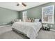 Bright main bedroom featuring two windows for natural light, ceiling fan and soft carpet at 543 Wayton Cir, Moncks Corner, SC 29461