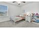 Bedroom features a ceiling fan, a bed with coral colored blanket, a window, and bookshelf at 543 Wayton Cir, Moncks Corner, SC 29461