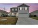 Charming two-story home with gray siding, gray shutters, an attached garage, and a manicured front yard at 543 Wayton Cir, Moncks Corner, SC 29461