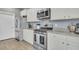 Stylish kitchen featuring stainless steel appliances, granite countertops, and white cabinets for a modern look at 543 Wayton Cir, Moncks Corner, SC 29461
