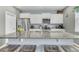 Well-designed kitchen featuring a large island with counter seating, granite countertops, and stainless steel appliances at 543 Wayton Cir, Moncks Corner, SC 29461