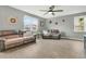 Comfortable living room with hardwood floors, ceiling fan, and large windows offering plenty of natural light at 543 Wayton Cir, Moncks Corner, SC 29461