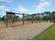 Community playground featuring swings, climbing area, slide and wood chip ground covering at 543 Wayton Cir, Moncks Corner, SC 29461