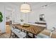 Tasteful dining room with modern lighting, farmhouse table, and views of the adjoining room at 709 Alma Square Dr, Moncks Corner, SC 29461