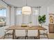A lovely dining room with a modern light fixture and an outside view from the window at 709 Alma Square Dr, Moncks Corner, SC 29461