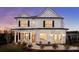 Charming two-story home with white siding, black shutters, and a welcoming front porch at 709 Alma Square Dr, Moncks Corner, SC 29461