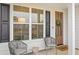 Inviting front porch with seating area, decorative wreath, and well-manicured landscaping at 709 Alma Square Dr, Moncks Corner, SC 29461