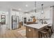 Spacious kitchen boasts stainless steel appliances, large island, and warm cabinets at 709 Alma Square Dr, Moncks Corner, SC 29461