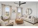 Bright living room with large windows, patterned drapes, and modern furniture at 709 Alma Square Dr, Moncks Corner, SC 29461