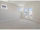 Bright and airy bedroom featuring carpet and double doors leading to a balcony with neighborhood views at 720 Rumbling Leaf Ln, Summerville, SC 29486