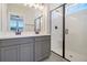 Bathroom featuring double sinks, white countertop, and glass shower with black trim at 722 Rumbling Leaf Ln, Summerville, SC 29486