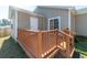 A charming home showcasing a cozy wooden back deck and sliding glass door, perfect for outdoor relaxation at 7919 New Ryder Rd, North Charleston, SC 29406