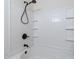 Bright bathroom featuring a shower with a black shower head and white tiled walls at 7919 New Ryder Rd, North Charleston, SC 29406