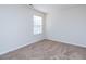A serene bedroom featuring neutral carpeting, light walls, and a bright window at 7919 New Ryder Rd, North Charleston, SC 29406
