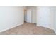 A bedroom featuring neutral carpeting, light walls, and two white doors at 7919 New Ryder Rd, North Charleston, SC 29406