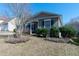 A charming single-story home with a landscaped front yard, complemented by green shutters at 7919 New Ryder Rd, North Charleston, SC 29406