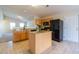 Open concept kitchen with island, granite counters, and black appliances, perfect for entertaining at 7919 New Ryder Rd, North Charleston, SC 29406