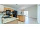 Bright kitchen with granite countertops, a center island, and black appliances overlooking dining area at 7919 New Ryder Rd, North Charleston, SC 29406