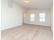 Spacious living room with neutral carpeting, bright windows, and ample natural light at 7919 New Ryder Rd, North Charleston, SC 29406