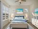 Tastefully decorated bedroom features a ceiling fan, bedside tables with lamps, and coordinating beach-themed artwork at 810 Gentle Breeze Dr, Summerville, SC 29486