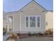 Charming home exterior with neutral siding, white trim, and well-maintained landscaping at 810 Gentle Breeze Dr, Summerville, SC 29486