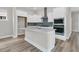 Modern kitchen boasts stainless steel appliances, a large island, and stylish blue backsplash at 810 Gentle Breeze Dr, Summerville, SC 29486