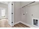 Practical laundry room with white door and closet with washer/dryer hookups at 810 Gentle Breeze Dr, Summerville, SC 29486