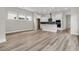 Open-concept living space showcasing wood-look floors and a modern kitchen with white cabinets at 810 Gentle Breeze Dr, Summerville, SC 29486