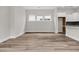 Bright living area with wood-look floors, large windows, and a modern kitchen at 810 Gentle Breeze Dr, Summerville, SC 29486
