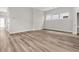Open living space with hardwood floors, large windows, and neutral wall colors at 810 Gentle Breeze Dr, Summerville, SC 29486