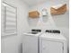 Bright laundry room featuring new white washer and dryer and convenient shelving at 8756 Silver Perch Ln, North Charleston, SC 29420