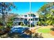 Expansive backyard with a pool, putting green, and screened porch, perfect for outdoor enjoyment at 886 White Point Blvd, Charleston, SC 29412