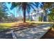 Backyard featuring a bocce court, palm trees, and lush greenery, perfect for outdoor activities at 886 White Point Blvd, Charleston, SC 29412