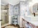 Charming bathroom with unique wallpaper, vanity and a glass-enclosed shower at 886 White Point Blvd, Charleston, SC 29412