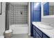 Charming bathroom with blue vanity, patterned shower tile, and a well-lit space at 886 White Point Blvd, Charleston, SC 29412