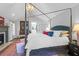 Tranquil bedroom with a canopy bed, fireplace, and reading nook with natural lighting at 886 White Point Blvd, Charleston, SC 29412