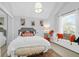 Cozy bedroom featuring a plush bed, window seat, and decorative artwork at 886 White Point Blvd, Charleston, SC 29412
