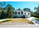 Inviting two-story home boasts a manicured lawn, charming stairway, and convenient two-car garage at 886 White Point Blvd, Charleston, SC 29412
