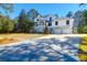 Charming exterior view featuring a large driveway leading to a two-car garage, complementing the home's facade at 886 White Point Blvd, Charleston, SC 29412