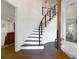 Elegant entryway featuring a curved staircase, hardwood floors, and shiplap walls at 886 White Point Blvd, Charleston, SC 29412