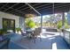 Covered outdoor patio with dining table, BBQ, and cozy seating area, perfect for entertaining at 886 White Point Blvd, Charleston, SC 29412