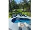 Secluded backyard featuring a sparkling pool with lounge chairs, and a serene view of the adjacent marsh at 886 White Point Blvd, Charleston, SC 29412