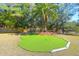 Private putting green featuring multiple holes for golf enthusiasts, set within a lush, landscaped yard at 886 White Point Blvd, Charleston, SC 29412