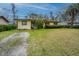 Charming home with a gravel driveway and well-kept front lawn, enhanced by mature landscaping and a welcoming facade at 1024 Locksley Dr, Charleston, SC 29407